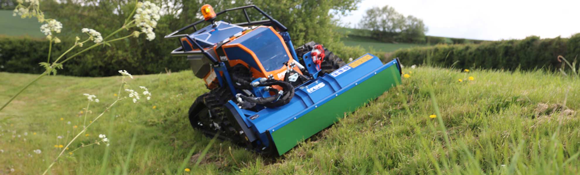 irus mower cutting grass on bank - Loxston Groundcare