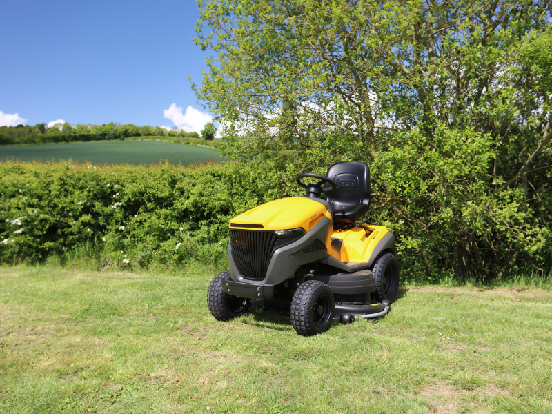 3 Loxston Groundcare ride on mower parked by hedge in field